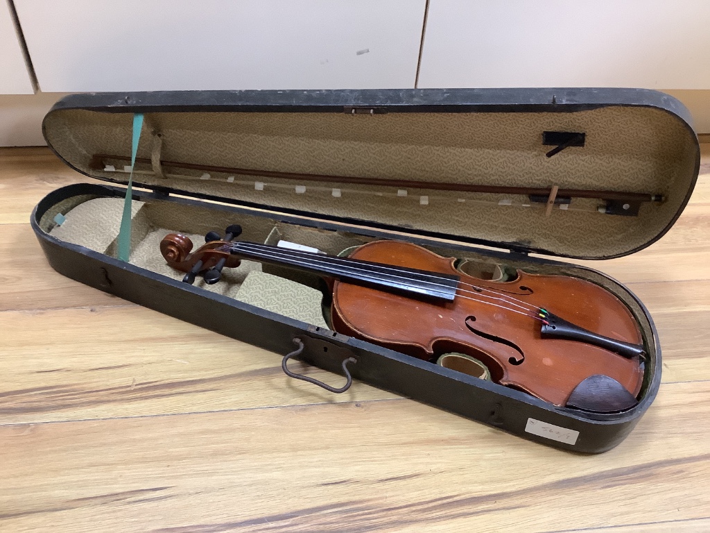 A violin and bow, in case, label to interior read Antonius Stadivarius Cremonensis, made in Czechoslovakia